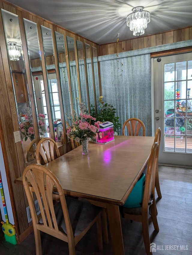 33 Cypress St, Carteret, NJ 07008 - dining space featuring wooden walls, a chandelier, and wood finished floors