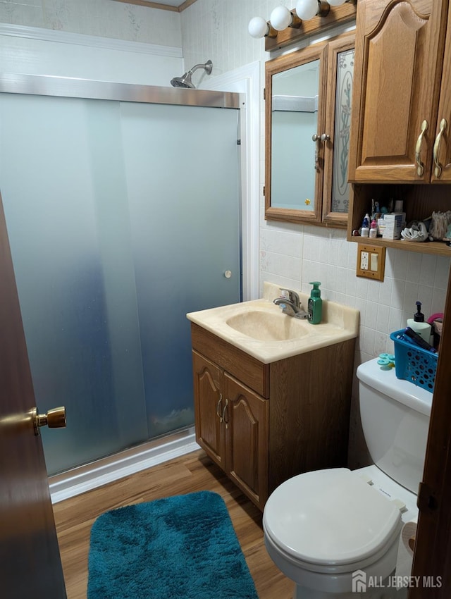 33 Cypress St, Carteret, NJ 07008 - bathroom featuring wood finished floors, vanity, a stall shower, and backsplash