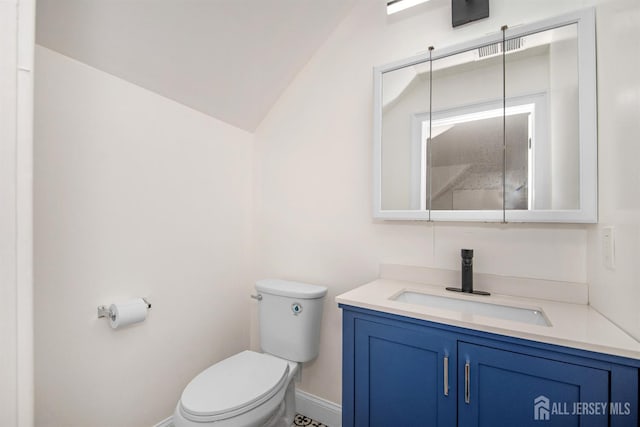 half bath featuring lofted ceiling, visible vents, toilet, vanity, and baseboards