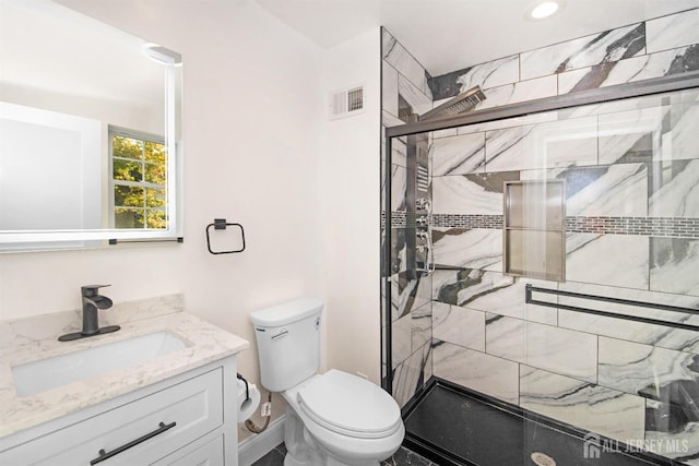 bathroom featuring a stall shower, visible vents, vanity, and toilet