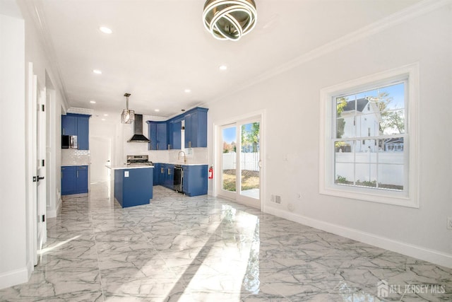 kitchen with wall chimney exhaust hood, ornamental molding, a center island, light countertops, and blue cabinetry