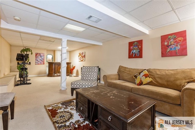 living room with a paneled ceiling, visible vents, carpet floors, and baseboards