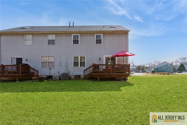 rear view of property with a deck, cooling unit, and a lawn