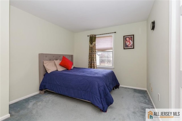 bedroom with carpet flooring and baseboards