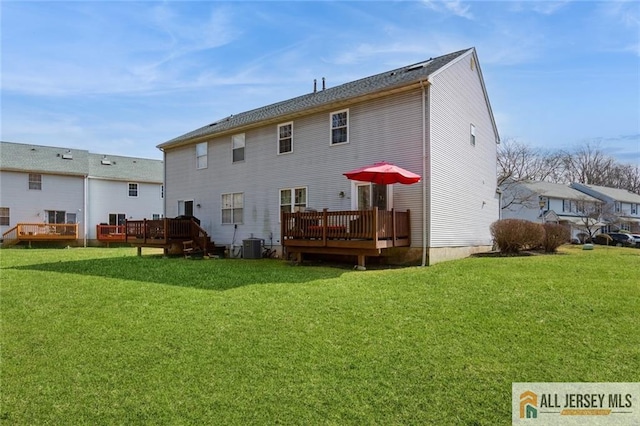 back of property featuring central AC unit, a lawn, and a deck