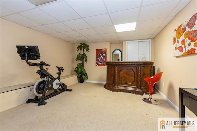 workout area with a drop ceiling and carpet floors