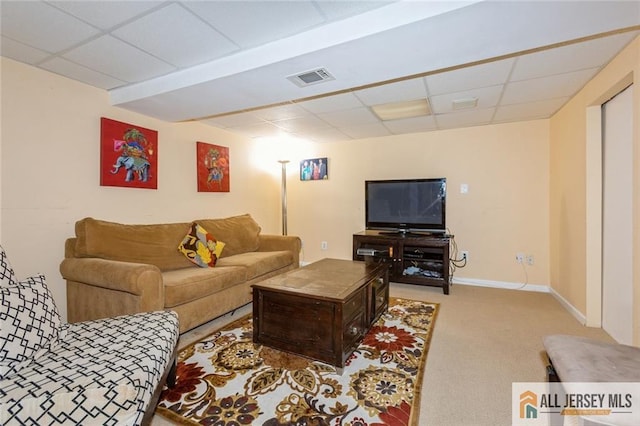 carpeted living area featuring visible vents, a drop ceiling, and baseboards