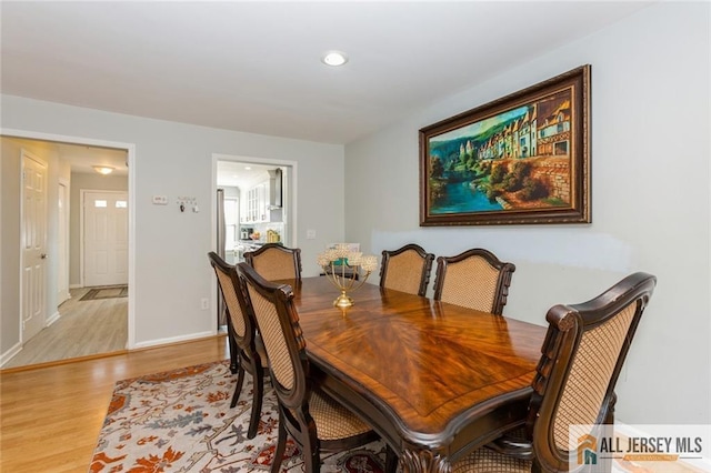 dining room with recessed lighting, wood finished floors, and baseboards