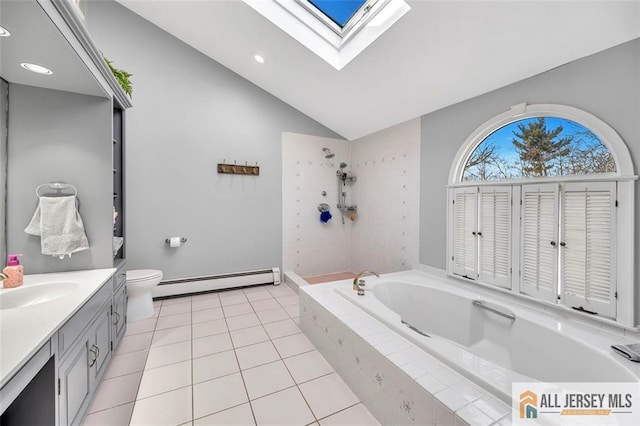 bathroom featuring toilet, a baseboard heating unit, vanity, a bath, and lofted ceiling with skylight