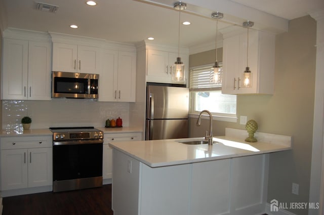 kitchen featuring appliances with stainless steel finishes, white cabinetry, and sink