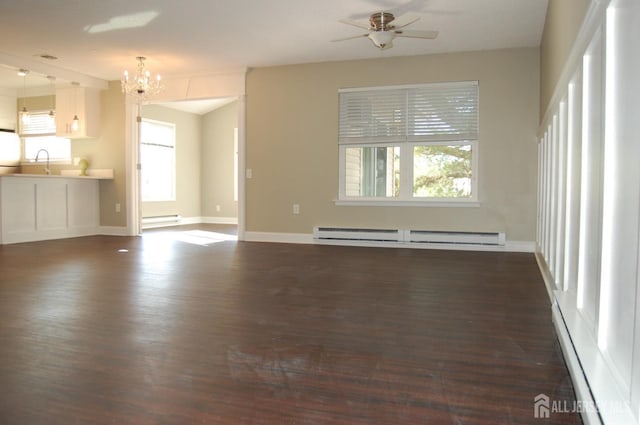 unfurnished living room with sink, dark hardwood / wood-style flooring, ceiling fan with notable chandelier, and a baseboard heating unit