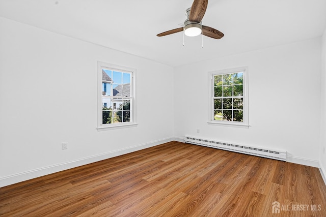 203 Rossmoor Dr Unit C, Monroe, NJ 08831 - unfurnished room with baseboard heating, wood finished floors, and a ceiling fan