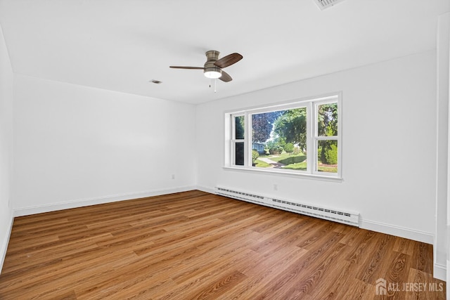 203 Rossmoor Dr Unit C, Monroe, NJ 08831 - empty room featuring a baseboard heating unit, wood finished floors, and ceiling fan