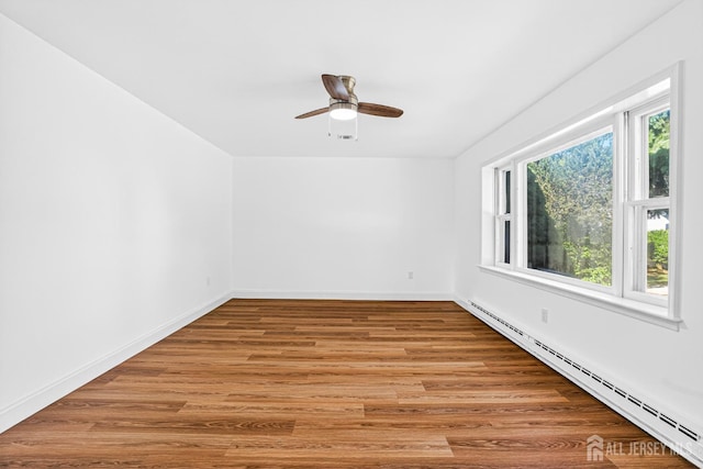 203 Rossmoor Dr Unit C, Monroe, NJ 08831 - unfurnished room featuring a baseboard radiator, a ceiling fan, and light wood finished floors
