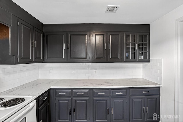 203 Rossmoor Dr Unit C, Monroe, NJ 08831 - kitchen featuring decorative backsplash, glass insert cabinets, and light stone counters