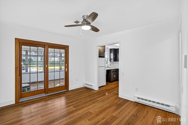 203 Rossmoor Dr Unit C, Monroe, NJ 08831 - spare room with baseboard heating, wood finished floors, and a ceiling fan