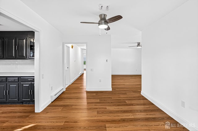 203 Rossmoor Dr Unit C, Monroe, NJ 08831 - unfurnished room featuring baseboard heating, ceiling fan, and wood finished floors
