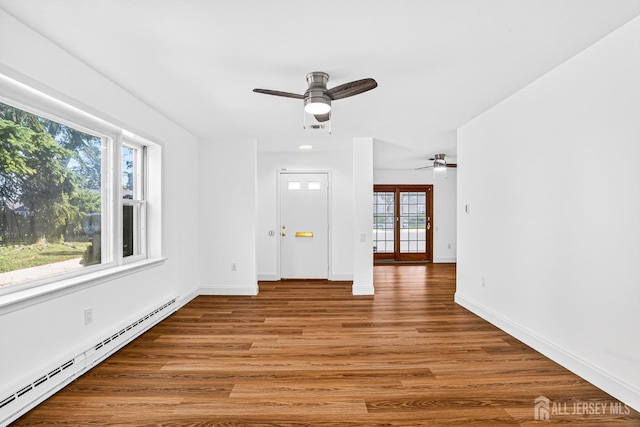 203 Rossmoor Dr Unit C, Monroe, NJ 08831 - empty room with baseboard heating, ceiling fan, and wood finished floors