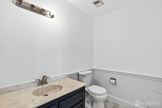 203 Rossmoor Dr Unit C, Monroe, NJ 08831 - half bathroom with wainscoting, vanity, and marble look tiles