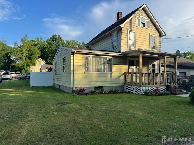 3350 E Washington Rd, Parlin, NJ 08859 - view of front of house featuring a porch, a chimney, and a front lawn