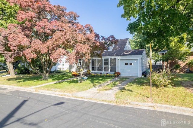 view of front facade with a garage and a front lawn