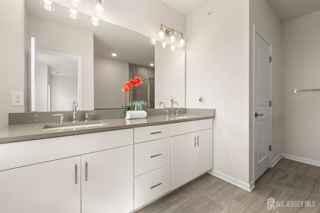 4 Arnold Dr Unit 5302, Wood-Ridge, NJ 07075 - bathroom with double vanity and baseboards
