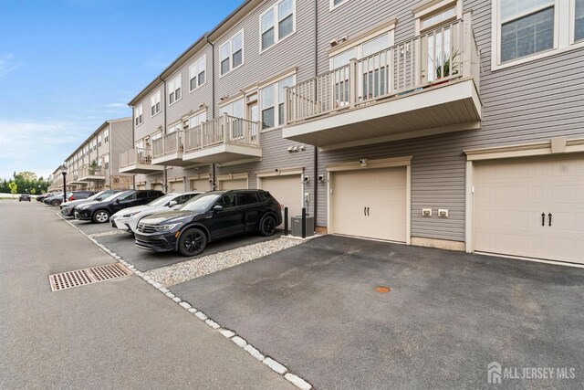 4 Arnold Dr Unit 5302, Wood-Ridge, NJ 07075 - view of building exterior with a garage and driveway