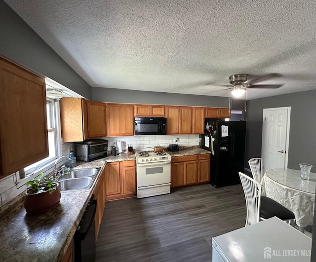 kitchen with decorative backsplash, brown cabinetry, dark wood-style flooring, black appliances, and a sink