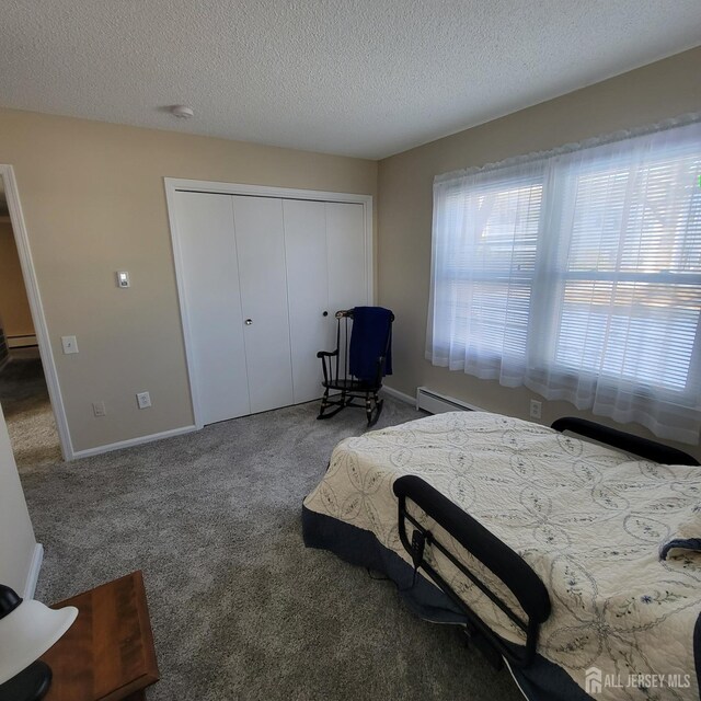 bedroom featuring carpet flooring, a closet, and a textured ceiling