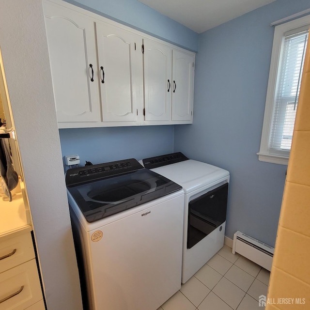 clothes washing area featuring baseboard heating, light tile patterned floors, washer and clothes dryer, and plenty of natural light