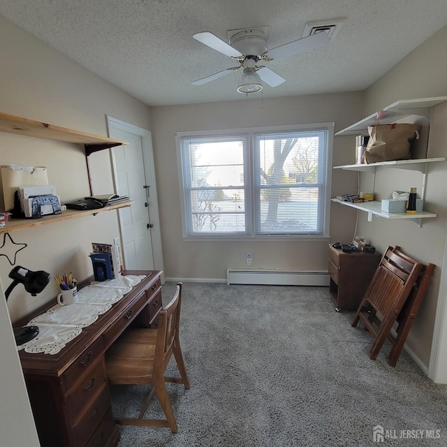 carpeted office featuring baseboard heating, a textured ceiling, and ceiling fan