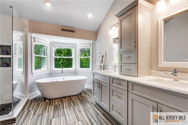 12 Wharton Ct, South Brunswick, NJ 08824 - full bathroom with double vanity, healthy amount of natural light, and a freestanding tub