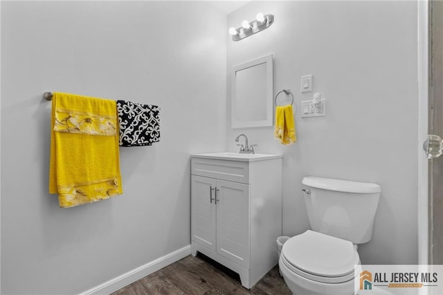 377 Ridge Rd, South Brunswick, NJ 08810 - bathroom featuring wood finished floors, toilet, vanity, and baseboards