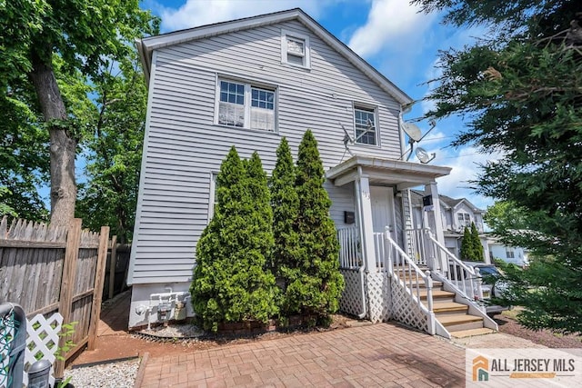 view of front of house featuring fence
