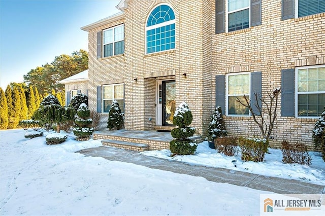 view of snow covered property entrance