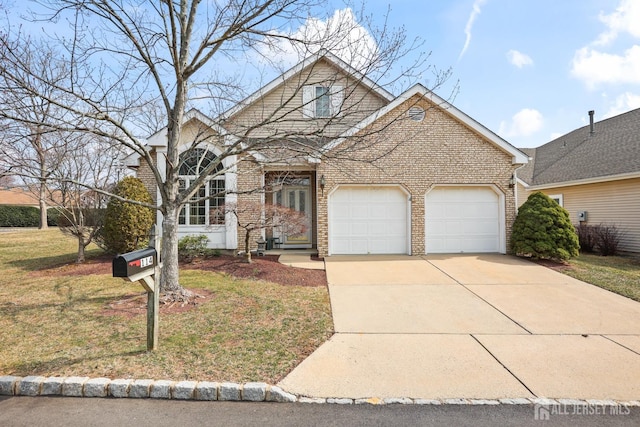 traditional-style home with brick siding, an attached garage, concrete driveway, and a front yard