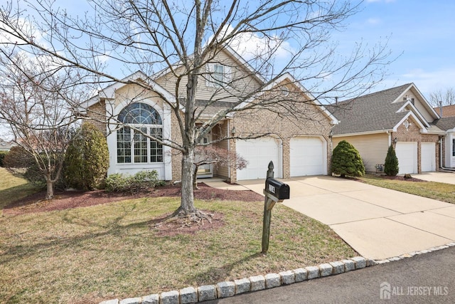 view of front of home featuring a garage, a front lawn, brick siding, and driveway