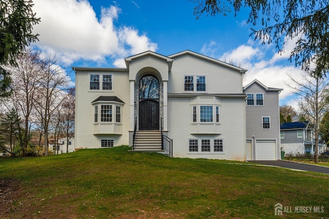 22 Mary Ellen Dr, Edison, NJ 08820 - view of front of house featuring stucco siding, asphalt driveway, a front yard, and a garage