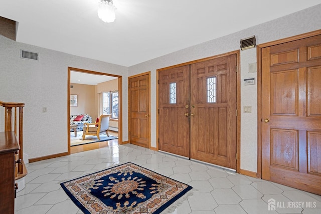 entryway with baseboards and visible vents