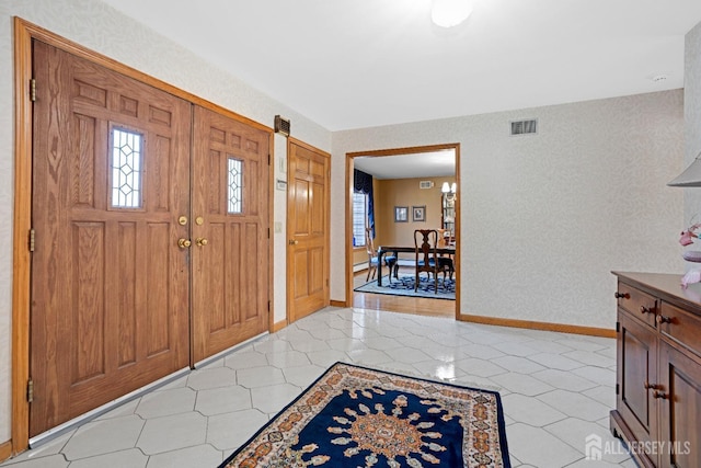 entryway with visible vents, baseboards, and light tile patterned flooring