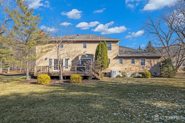 back of property featuring a lawn, a chimney, a wooden deck, and central air condition unit