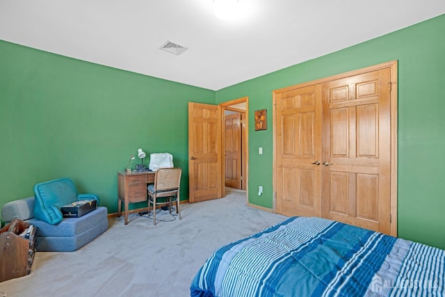 carpeted bedroom with visible vents and baseboards