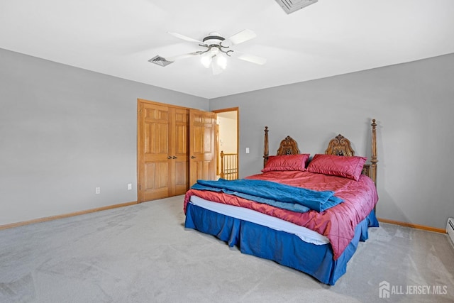 carpeted bedroom featuring baseboards, visible vents, and ceiling fan