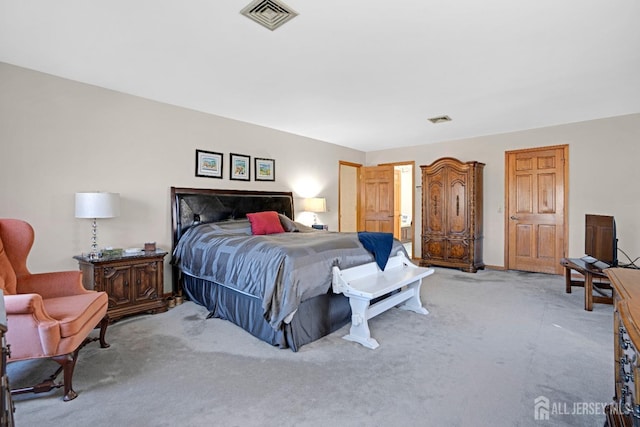 bedroom featuring light carpet and visible vents