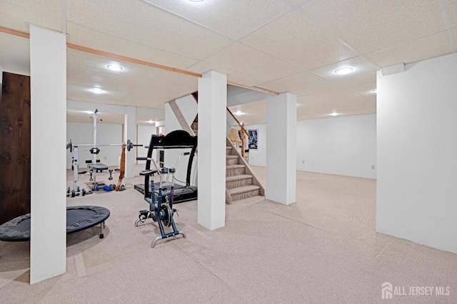 exercise room with carpet floors and a drop ceiling