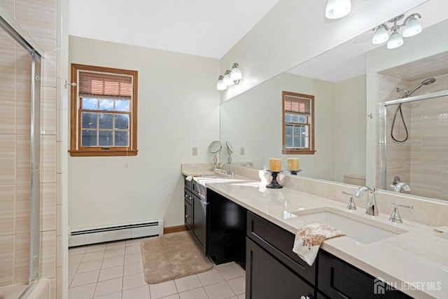 bathroom featuring a baseboard radiator, toilet, a sink, a tile shower, and double vanity