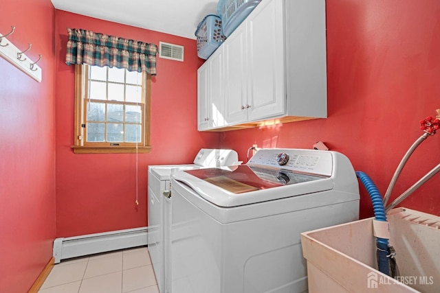 laundry area featuring cabinet space, visible vents, washing machine and clothes dryer, a baseboard heating unit, and light tile patterned flooring