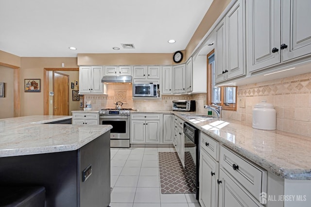 kitchen featuring visible vents, appliances with stainless steel finishes, under cabinet range hood, white cabinetry, and a sink