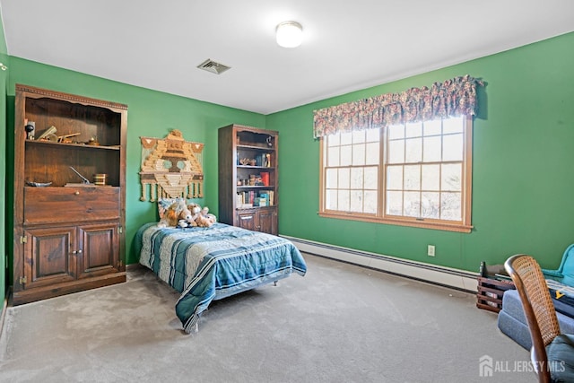 bedroom featuring visible vents, a baseboard heating unit, and light colored carpet