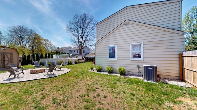 68 Applegate Ave, Monroe, NJ 08831 - view of yard featuring central AC unit, a fire pit, a storage shed, a patio, and an outbuilding